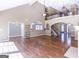 Spacious living room with hardwood floors, a fireplace, and an open floor plan to the kitchen at 401 Robinson Rd, Peachtree City, GA 30269