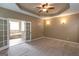 Inviting main bedroom featuring a ceiling fan and double doors leading to a relaxing ensuite bathroom at 401 Robinson Rd, Peachtree City, GA 30269