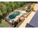Aerial view of backyard pool and deck with lush landscaping at 401 Robinson Rd, Peachtree City, GA 30269