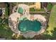 Aerial view of a backyard pool and hot tub surrounded by a stone patio at 401 Robinson Rd, Peachtree City, GA 30269