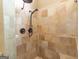 Walk-in shower with tan tile surround and bronze shower fixtures at 401 Robinson Rd, Peachtree City, GA 30269