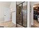 Modern bathroom with glass-enclosed shower and tiled walls, adjoining a walk-in closet at 1110 Eagles Brooke Dr, Locust Grove, GA 30248