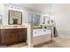 Luxurious bathroom featuring double vanities, a soaking tub, and tiled accents at 1110 Eagles Brooke Dr, Locust Grove, GA 30248