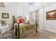 Cozy bedroom featuring a wrought iron bed frame, a large window, and sitting chair at 1110 Eagles Brooke Dr, Locust Grove, GA 30248