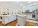 Bright kitchen with stainless steel appliances, white cabinets, and hardwood floors at 1110 Eagles Brooke Dr, Locust Grove, GA 30248