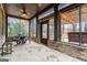 Covered back patio with stone floors, a ceiling fan, and an outdoor dining area at 1110 Eagles Brooke Dr, Locust Grove, GA 30248