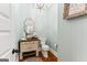 Charming powder room with rustic vanity, decorative mirror, and elegant light fixture at 1110 Eagles Brooke Dr, Locust Grove, GA 30248