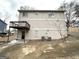 Back exterior of the house with a balcony, door, and air conditioning units at 5743 Rock Rd, Union City, GA 30291