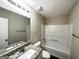 Well-lit bathroom with granite topped vanity, large mirror, and a shower-tub combination at 5743 Rock Rd, Union City, GA 30291