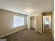Bedroom featuring a large window, closet, and tan carpeted floors at 5743 Rock Rd, Union City, GA 30291