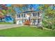 Two-story home featuring a wooden porch, attached garage, and lush green lawn at 5743 Rock Rd, Union City, GA 30291