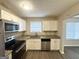 Well-lit kitchen with granite countertops, stainless steel appliances, and white cabinetry at 5743 Rock Rd, Union City, GA 30291