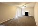 Carpeted living room with fireplace and sliding glass doors to the backyard at 5743 Rock Rd, Union City, GA 30291