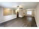 Bright living room with sleek dark floors, open floor plan, and view into kitchen at 5743 Rock Rd, Union City, GA 30291