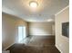 Spacious living room with neutral walls and carpet, plus sliding glass doors to the outside at 5743 Rock Rd, Union City, GA 30291