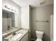 Cozy bathroom with a granite countertop vanity, a white toilet, and a shower-tub combo at 1202 Grove Trail Pass, Douglasville, GA 30134