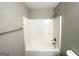Bathroom featuring a shower-tub combination, a new shower head, and a towel bar at 1202 Grove Trail Pass, Douglasville, GA 30134