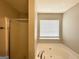 Bathroom features a shower-tub, tile flooring, and a window that provides natural light at 1202 Grove Trail Pass, Douglasville, GA 30134