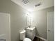 Bathroom featuring a vanity with granite countertop, a modern mirror, and a toilet at 1202 Grove Trail Pass, Douglasville, GA 30134