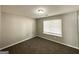Bedroom featuring neutral walls, plush carpeting, and a window offering natural light at 1202 Grove Trail Pass, Douglasville, GA 30134