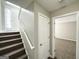 Entryway with carpeted stairs, coat closet, and open door to the bedroom at 1202 Grove Trail Pass, Douglasville, GA 30134