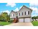 Charming two-story home with a well-maintained lawn, attached two-car garage, and inviting front entrance at 1202 Grove Trail Pass, Douglasville, GA 30134