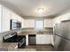 Beautiful kitchen featuring stainless steel appliances, granite countertops, and white cabinets at 1202 Grove Trail Pass, Douglasville, GA 30134