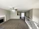 Spacious living room features neutral walls, carpet, a ceiling fan, and a fireplace with a brick hearth at 1202 Grove Trail Pass, Douglasville, GA 30134
