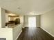 Open concept living room with hardwood flooring, neutral walls, and sliding glass doors to the backyard at 1202 Grove Trail Pass, Douglasville, GA 30134