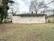 View of the house from the large backyard featuring a grass lawn and mature trees at 2310 Ousley Ct, Decatur, GA 30032