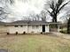 Traditional ranch home exterior featuring a neutral color palette and a covered carport area at 2310 Ousley Ct, Decatur, GA 30032