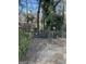Backyard with mature trees, a fence, and lush plants at 1125 Carlo Sw Ct, South Fulton, GA 30331
