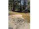 A backyard with a small patio provides a peaceful escape surrounded by lush trees at 1125 Carlo Sw Ct, South Fulton, GA 30331