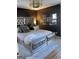 Stylish bedroom features a tufted headboard, soft textures, and decorative wall mirrors at 1125 Carlo Sw Ct, South Fulton, GA 30331