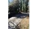 Paved driveway flanked by mature trees and a low brick retaining wall at 1125 Carlo Sw Ct, South Fulton, GA 30331