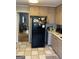 Kitchen includes a black refrigerator and access to another room, and a peek into another room at 1125 Carlo Sw Ct, South Fulton, GA 30331