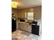 Functional kitchen with linoleum flooring, classic cabinetry, and standard appliances at 1125 Carlo Sw Ct, South Fulton, GA 30331