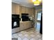 Well-lit kitchen with linoleum flooring and access to the rest of the home at 1125 Carlo Sw Ct, South Fulton, GA 30331