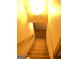 Carpeted staircase leading to the lower level with warm lighting at 1125 Carlo Sw Ct, South Fulton, GA 30331