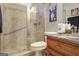 Bright bathroom featuring walk-in shower with glass door, granite countertop vanity and tiled flooring at 115 Foxford Run, Tyrone, GA 30290