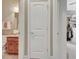 View from the bathroom into the primary closet, with a door between the spaces at 115 Foxford Run, Tyrone, GA 30290