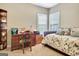 Bedroom featuring a full bed, chair and desk, with natural light from the windows at 115 Foxford Run, Tyrone, GA 30290