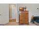 Bedroom with a dresser and tv, showcasing neutral walls and white doors with a glimpse into other rooms at 115 Foxford Run, Tyrone, GA 30290
