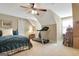 Bedroom with a ceiling fan and treadmill, featuring sloped ceilings and a window with natural light at 115 Foxford Run, Tyrone, GA 30290