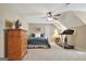 Bedroom features a bed, dresser, treadmill, ceiling fan, and sloped ceilings with a bonus room at 115 Foxford Run, Tyrone, GA 30290