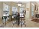 Bright breakfast nook features a bistro table, four chairs, and natural lighting from large surrounding windows at 115 Foxford Run, Tyrone, GA 30290