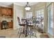 Bright dining area with windows, an elegant light fixture, and seating for four near the kitchen at 115 Foxford Run, Tyrone, GA 30290