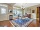 Elegant dining area showcases a beautiful rug, chandelier, and large windows for natural light at 115 Foxford Run, Tyrone, GA 30290