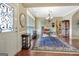 Elegant dining area showcases a beautiful rug, chandelier, and large windows for natural light at 115 Foxford Run, Tyrone, GA 30290