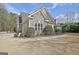 Charming home features stone accents, manicured landscaping, and a welcoming two-car garage at 115 Foxford Run, Tyrone, GA 30290